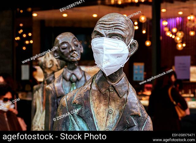 Melbourne, Australia - October 27, 2020: Bourke St and Swanston St in Melbourne and the famous 'Three Businessmen Who Brought Their Own Lunch' sculptures during...