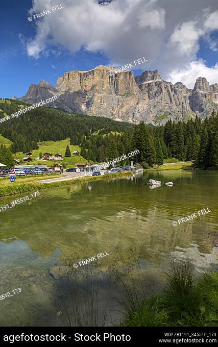 Lake near Hotel Lupo Bianco Wellness & Walking Canazei, Passo Pordoi with mountain backdrop, South Tyrol, Italian Dolomites, Italy, Europe