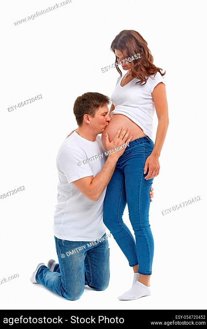 Happy family. Young man with pregnant wife, isolated on white background. Concept of family and parents