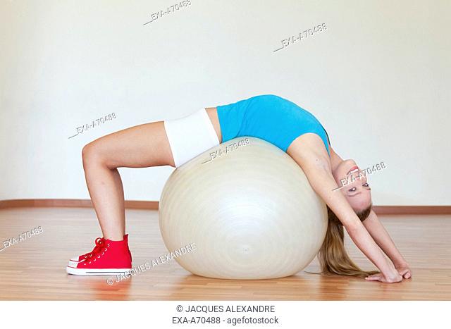 Woman trains with exercise ball