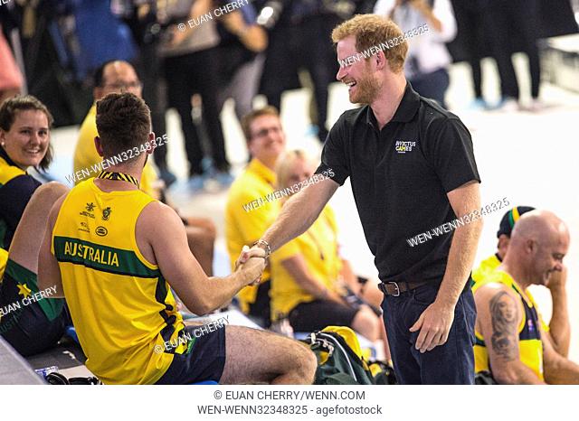 Prince Harry sneaks up on a sleeping Australian athlete as he attends Invictus Games Sports training at the Toronto Pan Am Sports Centre