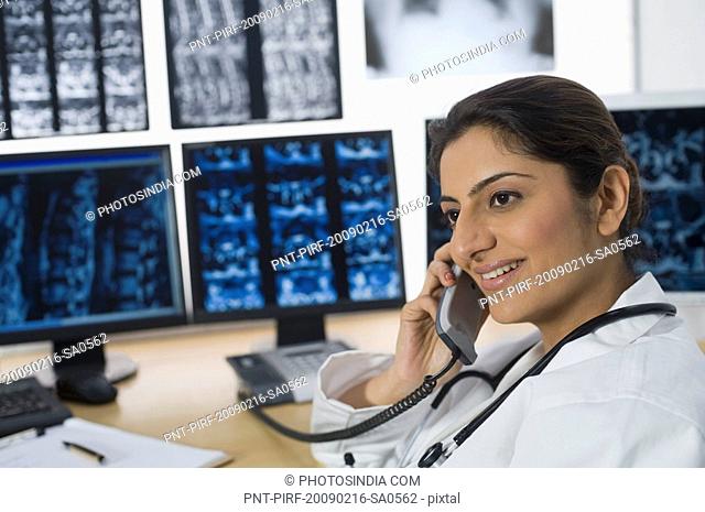 Female doctor talking on a phone and smiling