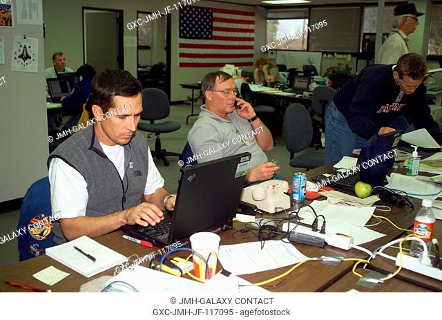 Astronauts John B. Herrington (foreground working on laptop) and Jerry L. Ross work at the Lufkin Command Center while assisting the STS-107 mishap support team