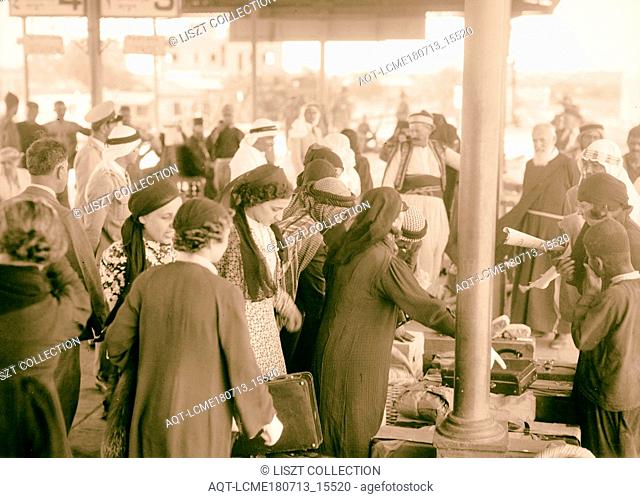 Palestine delegation of Arab ladies leaving Lydda Junction for Cairo, Oct 12, 1938. Unposed crowd, claiming baggage, a busy moment before departure, Israel, Lod