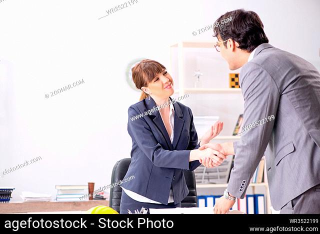 Man and woman discussing construction project