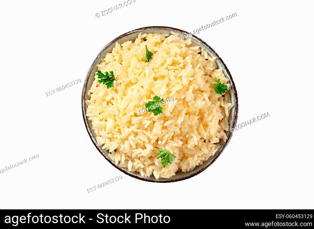 Rice, shot from above, isolated on a white background with a clipping path. Minimal dish, cooked, served with fresh parsley leaves