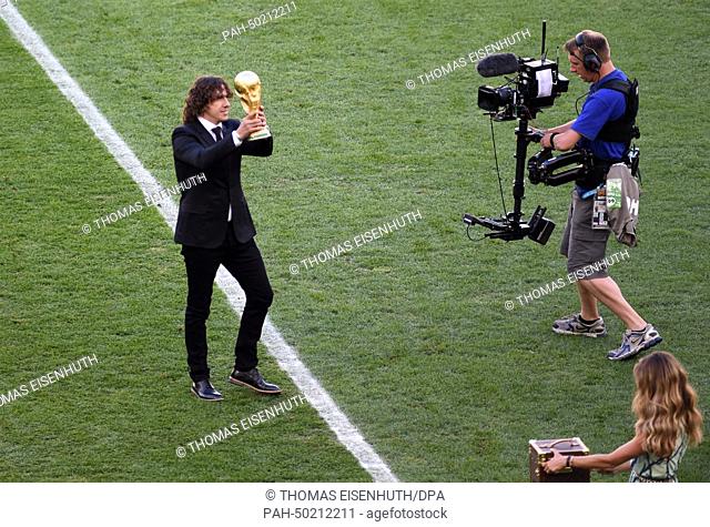 Former soccer Carles Puyol of Spain arrives with World Cup trophy prior to the FIFA World Cup 2014 final soccer match between Germany and Argentina at the...
