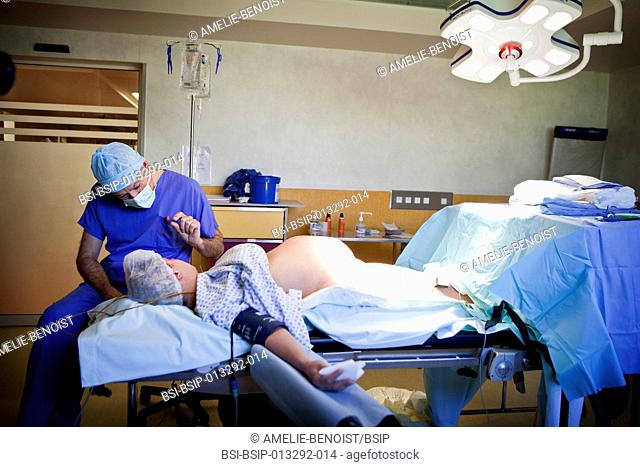 Reportage on a cesarean under hypnosis, in the maternity ward of Saint-Grégoire hospital in Rennes, France. The anaesthetist hypnotises the patient while...