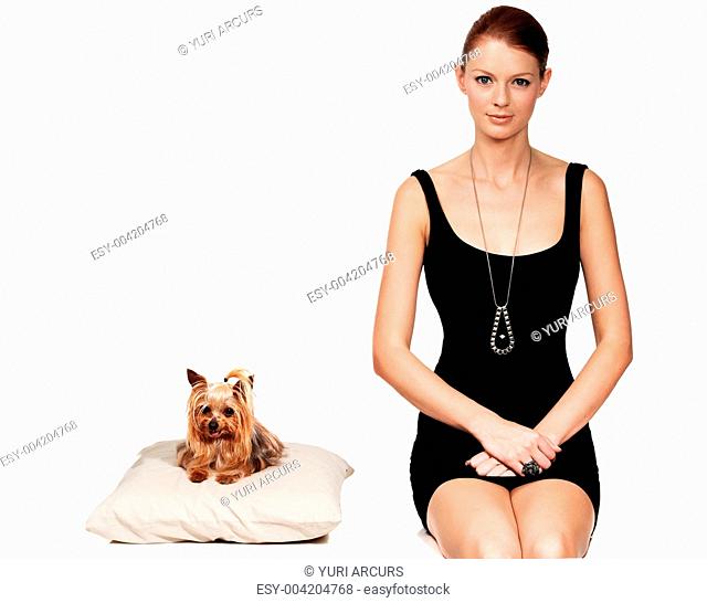 Portrait of an elegant young lady sitting next to her dog
