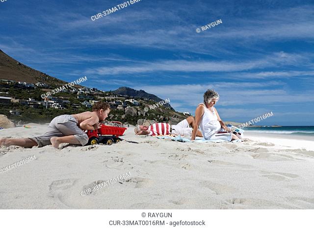 Older couple on beach with grandson