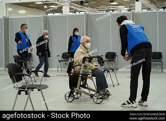 18 January 2021, Berlin: A helper (r) talks to Irma Deskowski(101), who is resting for a moment after being vaccinated against Covid-19 at the vaccination...