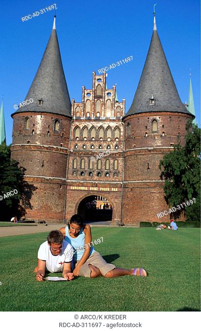 Couple in front of the Holstentor, Luebeck, Schleswig-Holstein, Germany