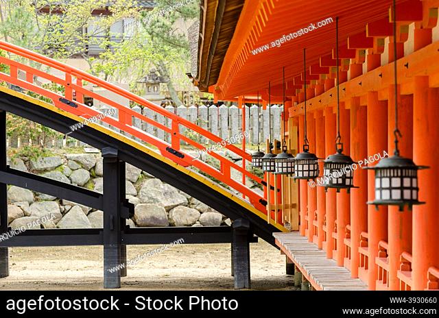 Lanterns and wooden bridge at the main temple of Itsukushima Shrine in Miyajima, Japan