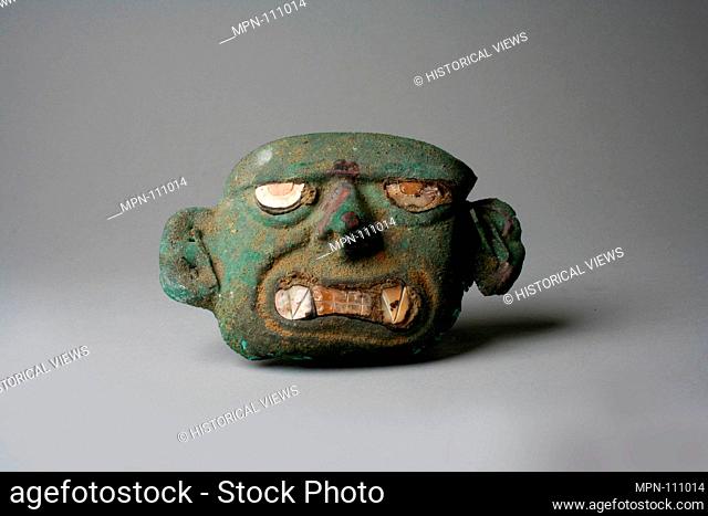 Face Mask Ornament. Date: 390-450; Geography: Peru; Culture: Moche (Loma Negra); Medium: Silvered copper, shell; Dimensions: H x W: 2 5/8 x 4in. (6