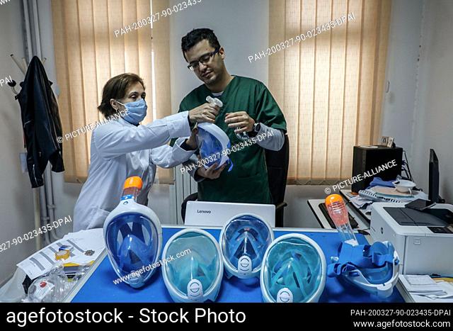 27 March 2020, Tunisia, Tunis: Youssef El Hachemi (R), Tunisian doctor, and anther colleague re-install a diving mask, as Hachemi launched a campaign to donate...