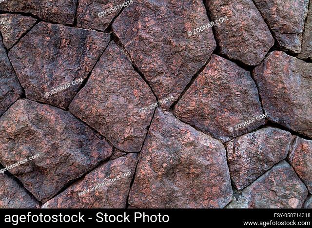 Panel background of folded even natural stones of red-brown color bonded without cement