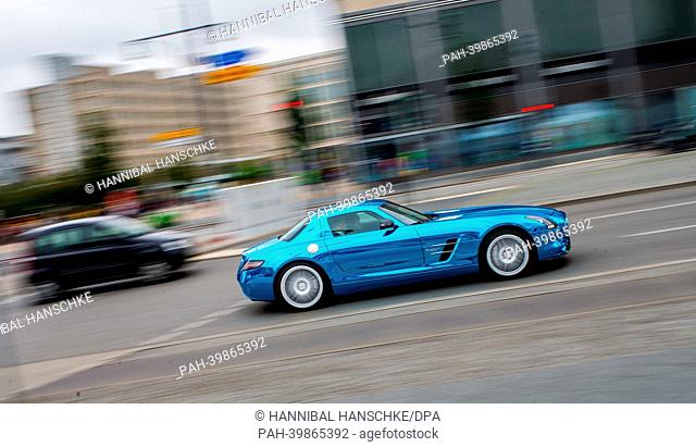 A Mercedes SLS AMG Electric Drive goes past Alexanderplatz at the International Conference on electric mobility at Congress Centrum (bcc) in Berlin, Germany