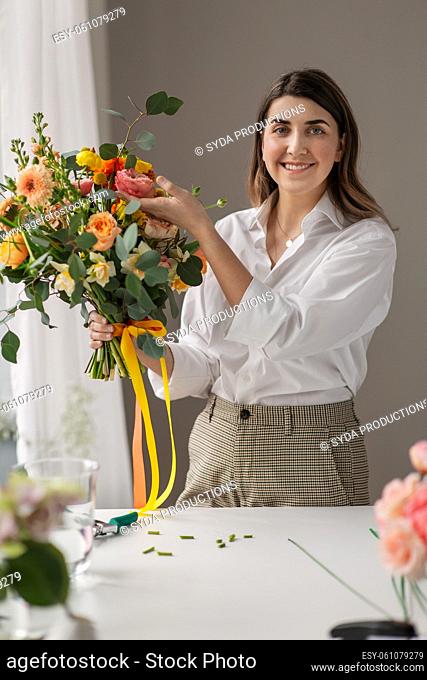 happy woman with bunch of flowers at home
