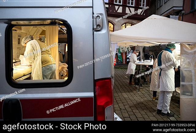 17 December 2020, Baden-Wuerttemberg, Tübingen: Employees work at a Mobile Corona Test Station. The tests are developed in the car and the smears are taken next...