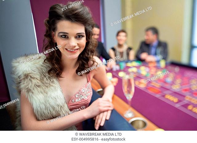 Woman in fur taking break from roulette in casino