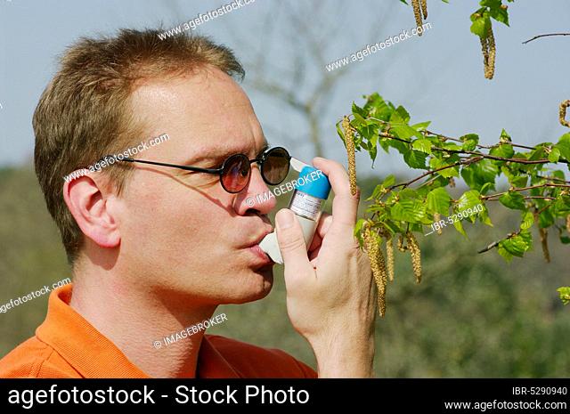 Man with inhaler, inhaling, allergy, birch, birch pollen, pollen allergy, hay fever, breath spray, inhalation