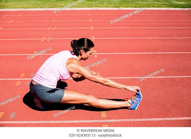 Female athlete stretching her hamstring