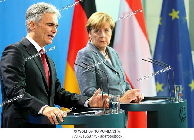 German Chancellor Angela Merkel (R) and her Austrian counterpart Werner Faymann attend a joint press conference on the future course of action of both countries...