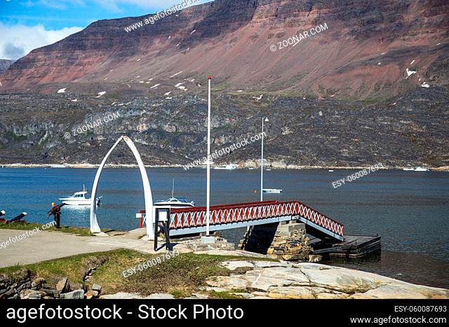 Qeqertarsuaq, Greenland - July 6, 2018: The jetty at the harbour with bowhead whale jawbone made into arch. Qeqertarsuaq is a port and town located on the south...