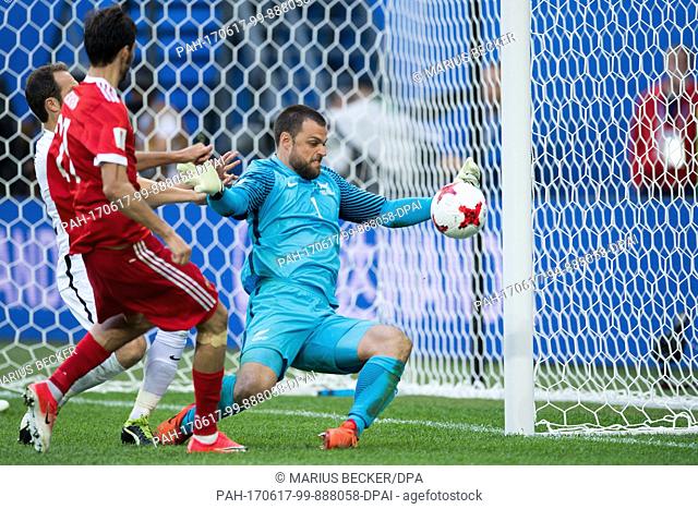 New Zealand goalkeeper Stefan Marinovic (r) blocks a shot by Russia's Aleksandr Erokhin during the Confederations Cup Group A soccer match between Russia and...
