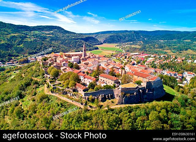 Buzet. Hill town of Buzet surrounded by stone walls in green landscape aerial view. Istria region of Croatia