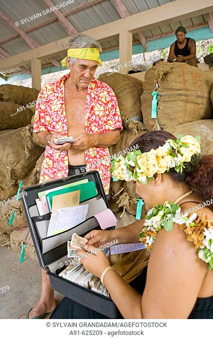 Stopover in Puamau, Hiva Oa island. Purser Mauahiti Fuatapu buying coprah from Tehautiama Alfred Tipahaehae, grand son of Paul Gauguin, born in 1941