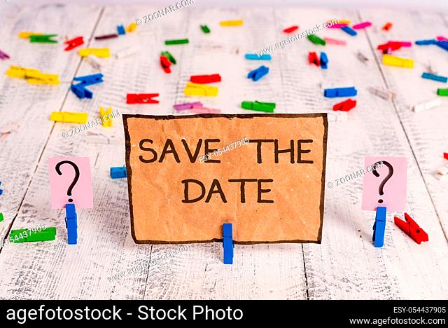 Conceptual hand writing showing Save The Date question. Concept meaning asking someone to remember specific day or time Crumbling sheet with paper clips placed...