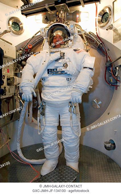 Astronaut Michael E. Fossum, STS-121 mission specialist, participates in an Extravehicular Mobility Unit (EMU) spacesuit fit check in the Space Station Airlock...