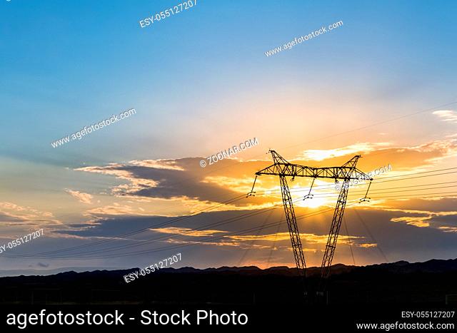 sunset silhouette of power transmission tower