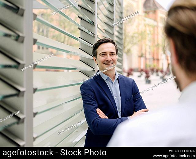 Smiling mature businessman meeting with a colleague in the city