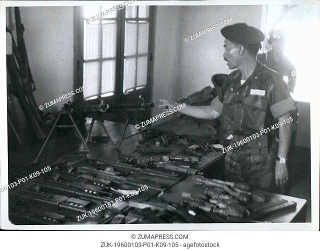 Jan. 09, 1958 - Sub. Briq. Sen. Nguyen Chanh Thi Commander of Vietnamese Division, (bordering North Vietnam) looks over captured Viet Cong Suerrilla weapons -...