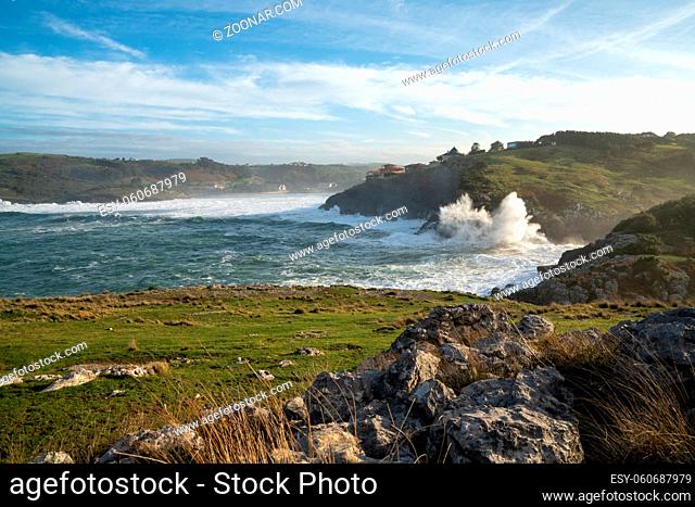 A view of huge storm surge ocean waves crashing onto shore and cliffs at La Sorrozuela village in Spain