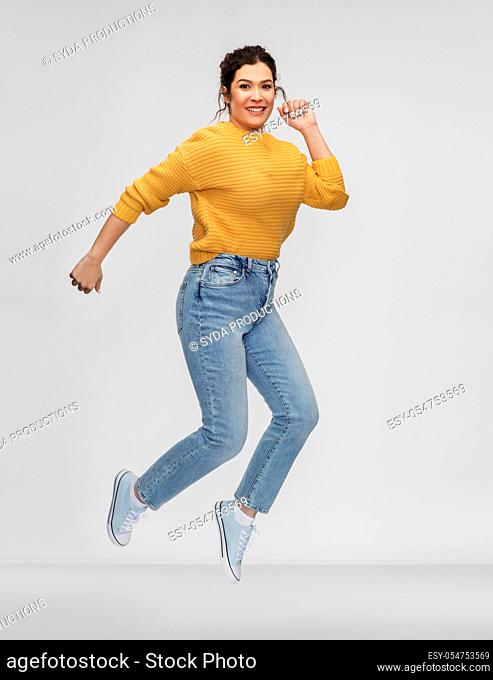 happy young woman with pierced nose jumping