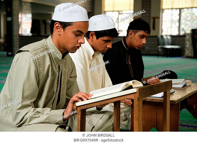 Muslim boys reading the Koran in a Mosque