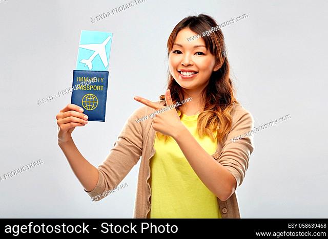 asian woman with air ticket and immunity passport