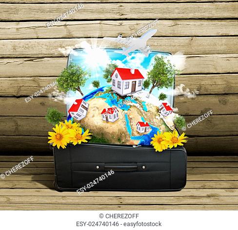 Earth with buildings, trees and travel bag on old wooden surface. Elements of this image are furnished by NASA