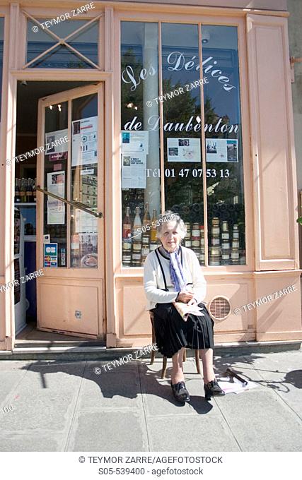 Woman in front of an old business in Paris. France