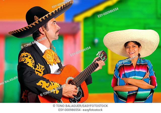 Mexican mariachi charro man and poncho Mexico girl colorful facade houses