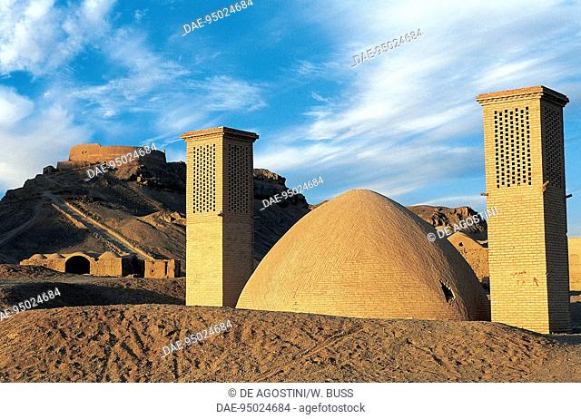 Zoroastrian building with badgirs (wind towers) with the Tower of Silence in the background on the left, Yazd, Iran