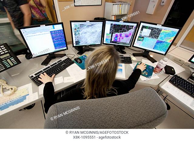 Meteorologist Cindy Fay of the National Weather Service office in Hastings, Nebraska, works a forecast and monitors current conditions on four monitors