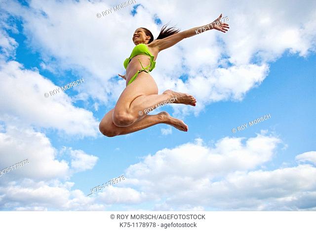 Woman in bikini, jumping