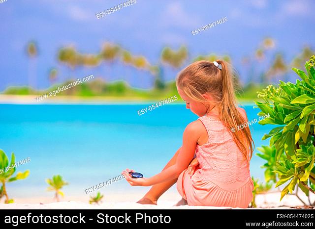 Little girl traveler with a compass in the hand