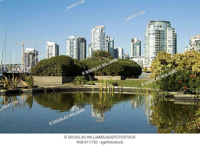 pond near False Creek, view of Yaletown condo towers, Vancouver, BC, Canada