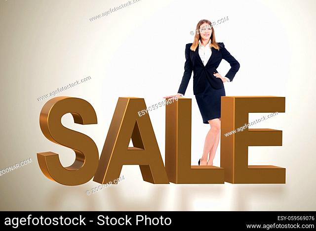 Woman standing next to SALE word