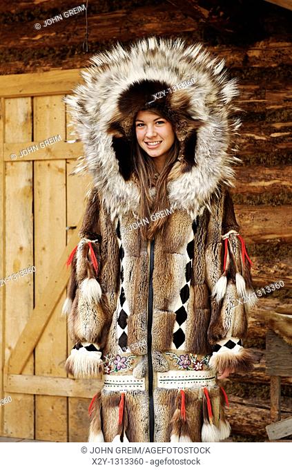 Young Athabascan woman modeling the traditional fur clothing of her native tribe, Chena Indian village, Alaska
